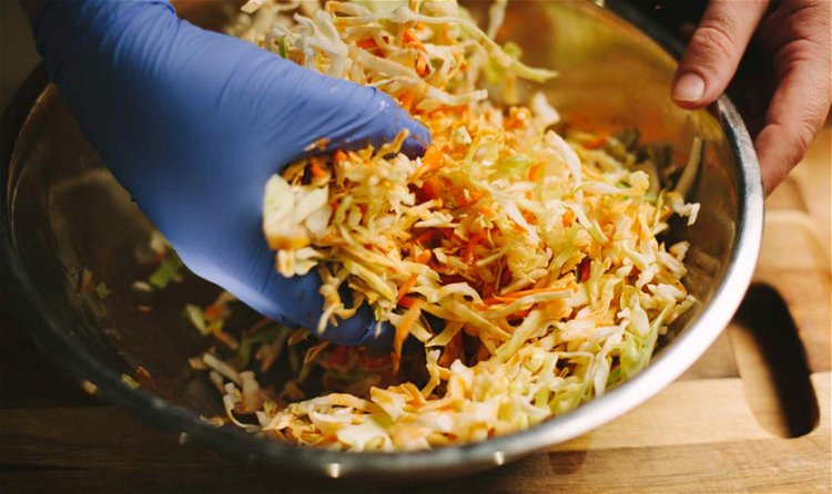 Image of Combine the slaw mix, cilantro and green onions in a...