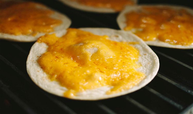 Image of Place your tortillas on the grill topped with the shredded...