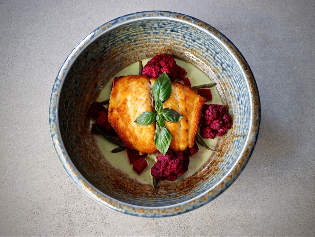 Pan Seared Black Grouper over pickled Vegetables, coconut serrano sauce