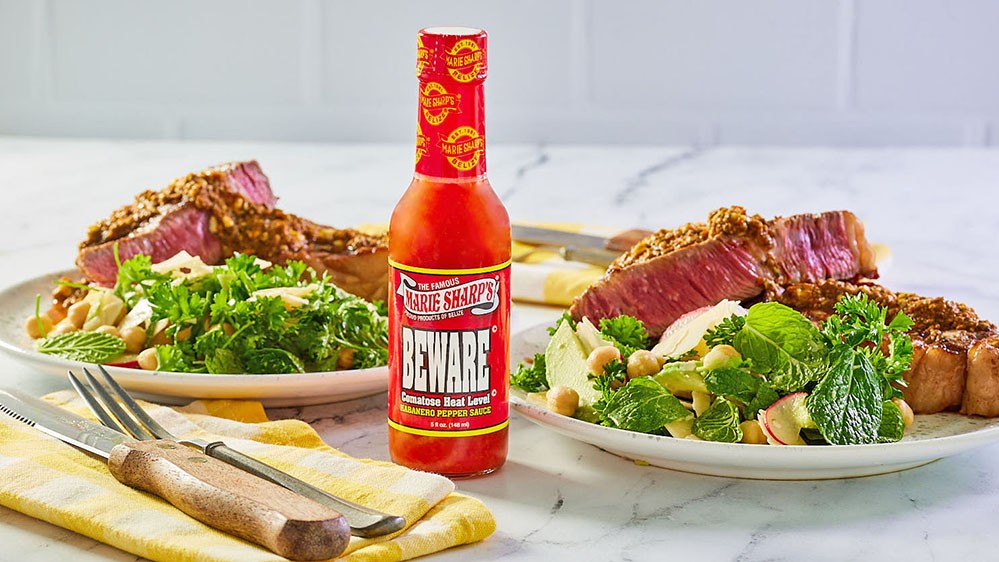 Image of Rib-eye with Pesto Butter and Herb Salad and Marie Sharp’s Beware Comatose Habanero Pepper Sauce