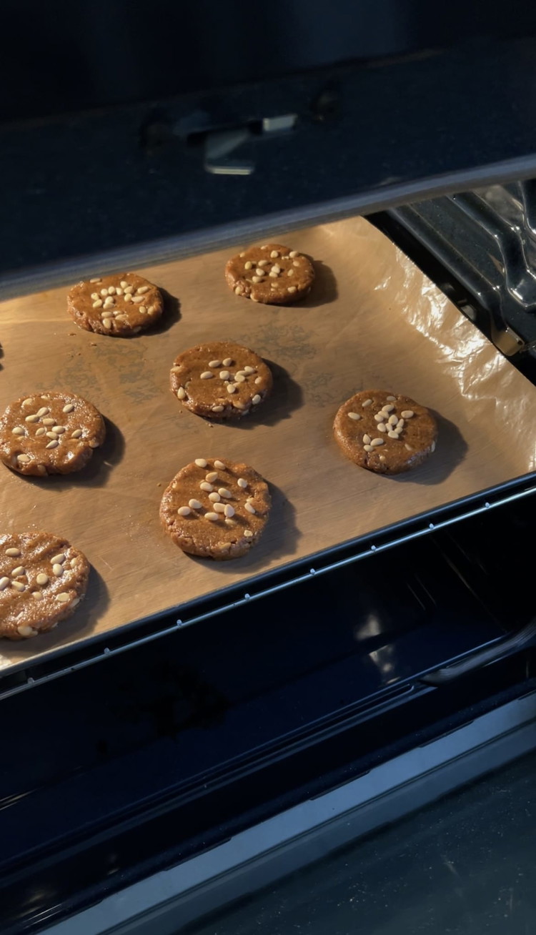 Image of Line a tray with baking paper. Take about 1 1/2 tbsp of dough for each cookie and shape them into flat disks, then place them on the tray. Top with pine nuts, and gently press them into the cookies. Bake...