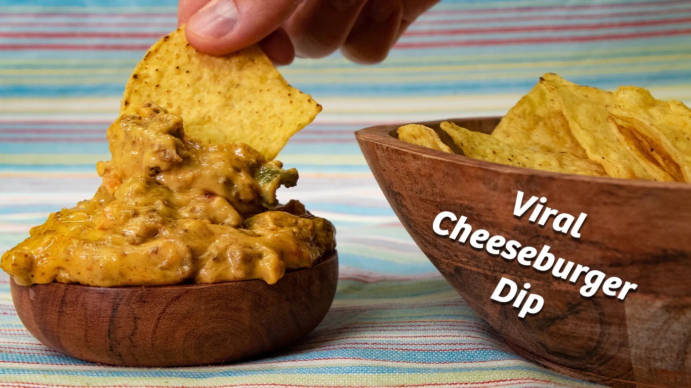 Midamar Halal Cheeseburger Dip in bowl being picked up by tortilla chip