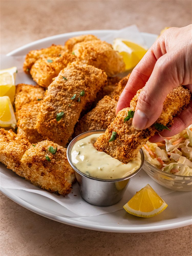 Image of While walleye cooks, stir together ingredients for tartar sauce in...