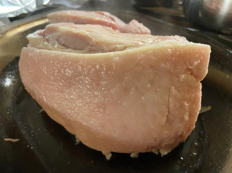Image of Carefully pour cider round the meat so the base of the pan is covered and put into oven