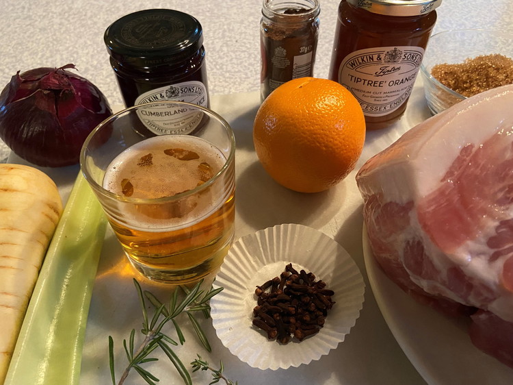 Image of Put an inch of water in a large pan then place gammon in the pan, add celery, onion, carrot, herbs and peppercorns, add more cold water until it just covers meat