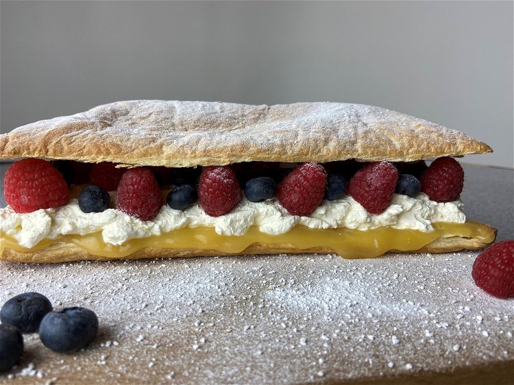Image of Place pastry lid on the fruit, dust with icing sugar...