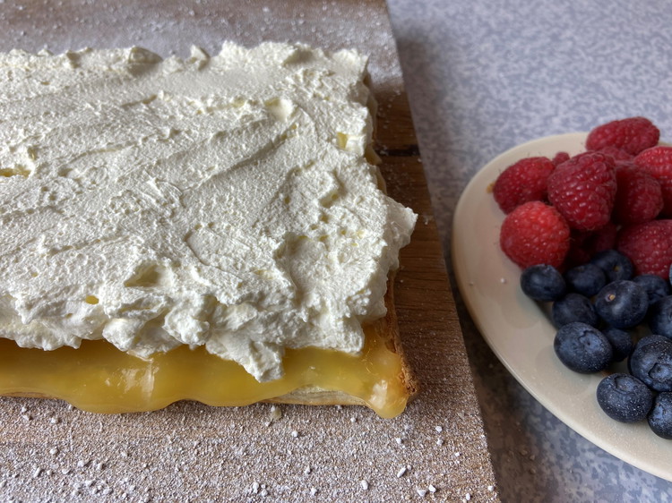 Image of Whip cream until stiff and fold in Crème Fraiche and spread on top of Lemon Curd