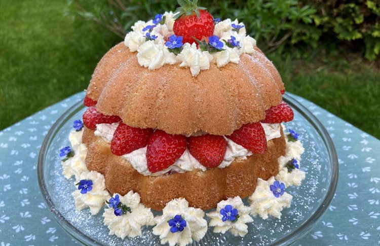 Image of Decorate the cake with more strawberries, cream rosettes and fresh borage flowers