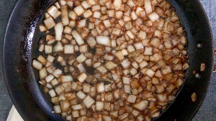 Image of Add onions to bacon grease and cook until browned on...