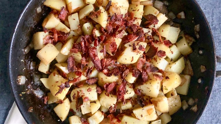 Image of Add potatoes and bacon bits. Cook for five minutes.