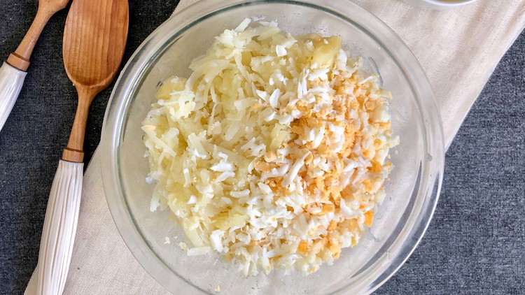 Image of Cook the peeled potatoes and eggs. Allow to fully cool before grating using sing a potato/cheese grater or salad master.