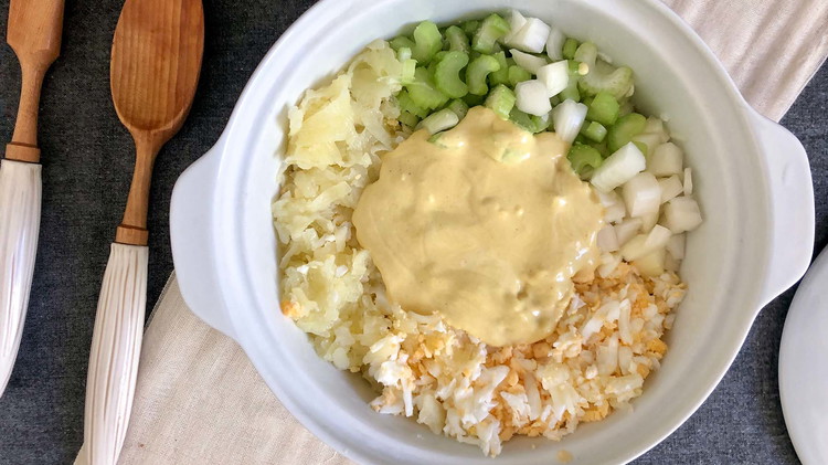 Image of Pour dressing over potatoes and gently toss to fully coat all ingredients. Be careful when mixing to avoid mushy potatoes.