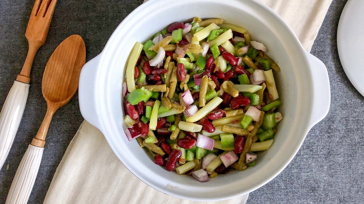 Image of Combine dressing with three beans, onion, and bell pepper. Refrigerate overnight before serving.