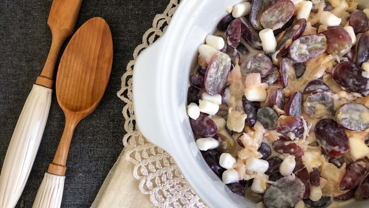 Image of Add pineapple and marshmallows to the sauce. Then fold in whipped cream and add grapes.