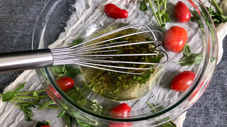 Image of In a small mixing bowl, whisk olive oil, vinegar, sugar, salt, and basil and set aside.
