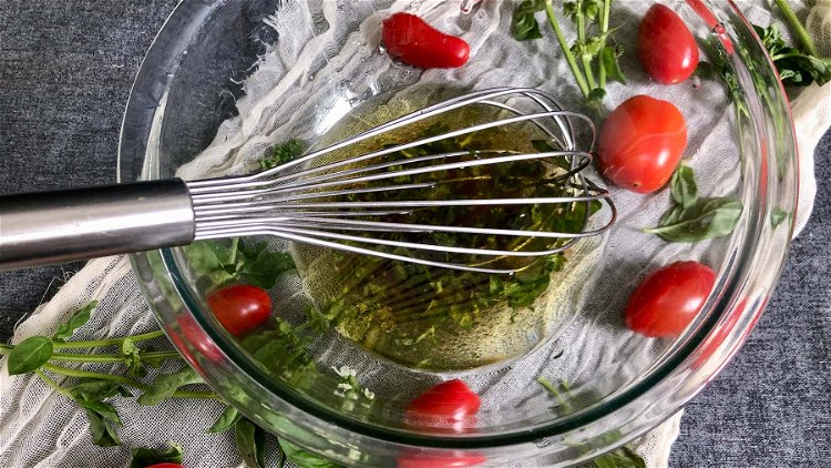Image of In a small mixing bowl, whisk olive oil, vinegar, sugar,...