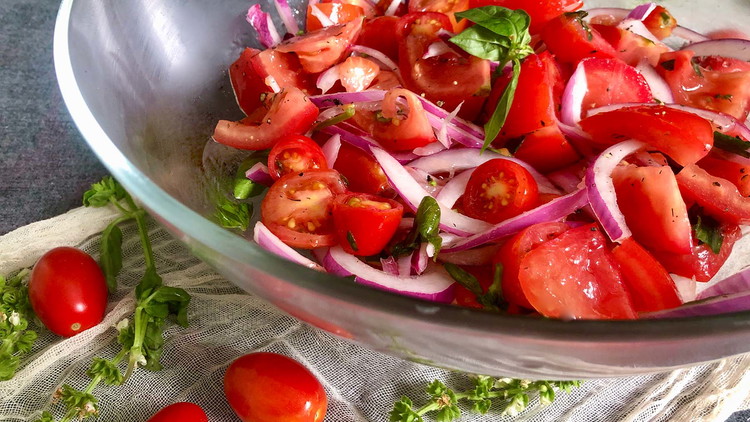 Image of Combine well tomatoes, onions, and olive oil dressing. Store in refrigerator for 3-4 hours before serving. Upon serving, garnish with fresh basil, salt, and pepper.