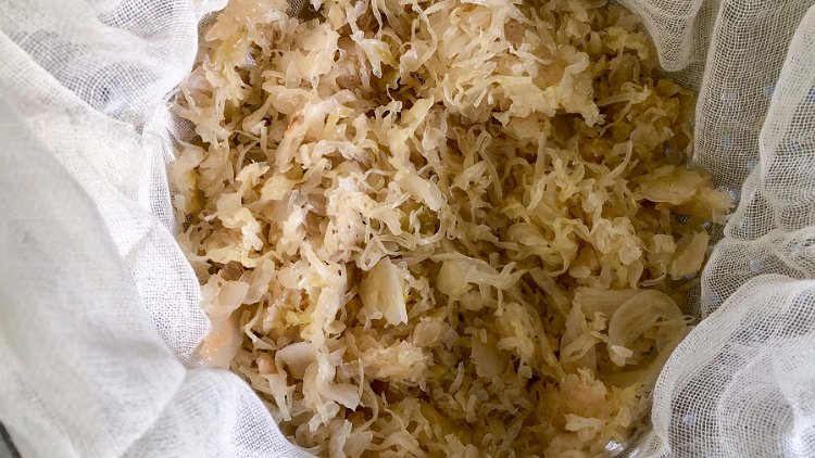 Image of Drain and rinse sauerkraut. Place cheesecloth in a colander and...