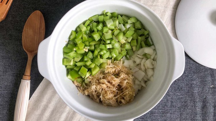 Image of Combine sauerkraut, celery, onion, and green bell pepper. Set aside.