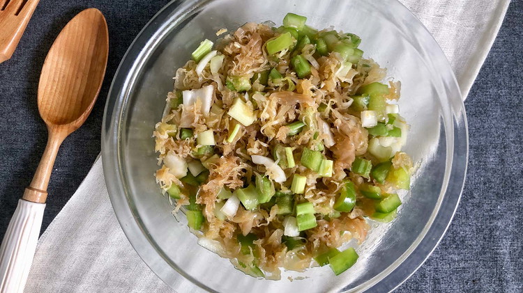 Image of Transfer the sauerkraut, celery, onion, and pepper mixture to the sauerkraut dressing bowl. Combine well so all parts are equally covered.