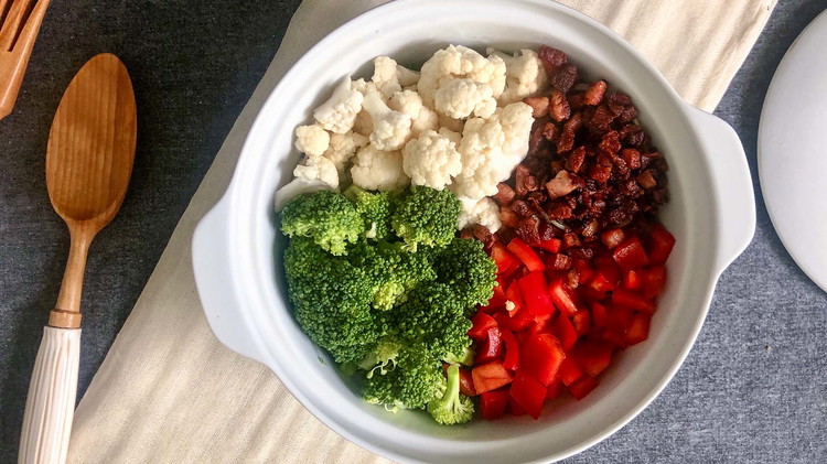 Image of In a mixing bowl stir together the broccoli, cauliflower, red bell pepper, and bacon. Set aside. Optional: Blanch or steam broccoli and cauliflower.