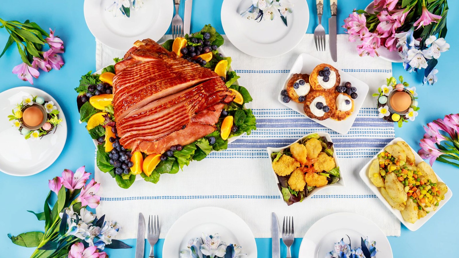 https://images.getrecipekit.com/20230322024812-festive-easter-table-with-ham-salad-and-pancakes-2022-11-17-23-23-25-utc.jpg?class=16x9