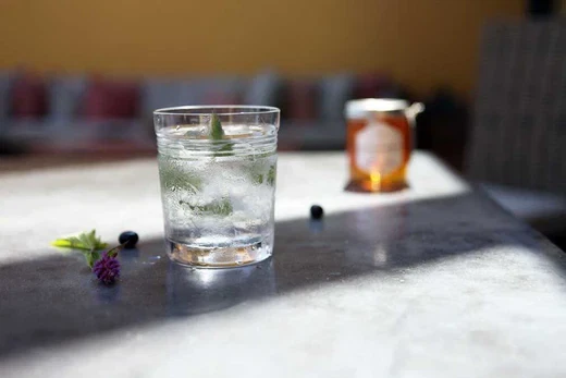 eastern shore honey vodka cocktail on table with berries