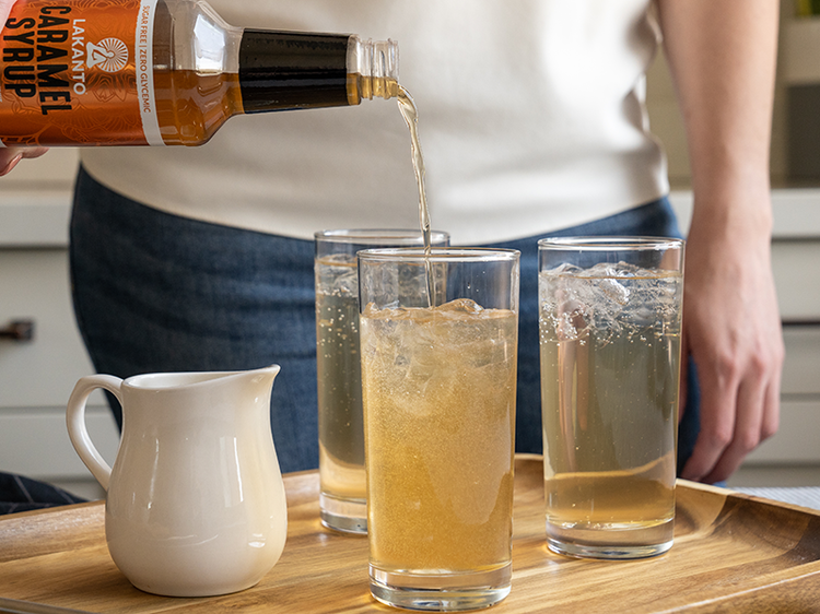 Image of Next, pour Lakanto Caramel Simple Syrup and heavy whipping cream into the glass and mix with a spoon or straw.