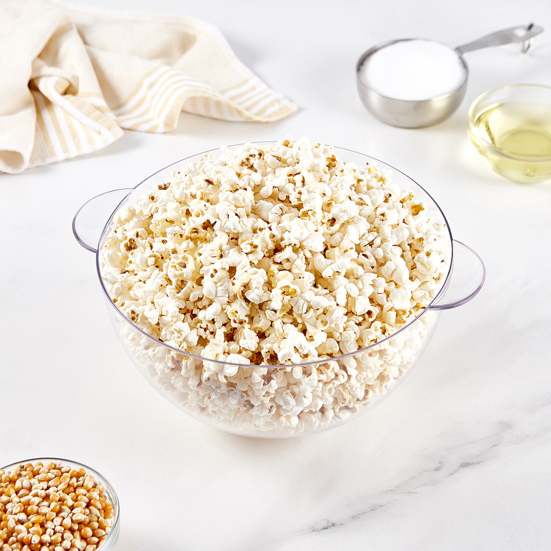 A clear bowl filled with popped kettle corn.