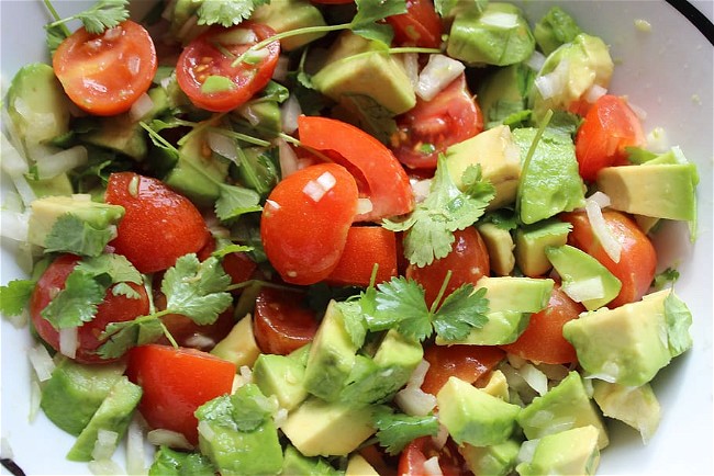Image of Guacamole (mashed avocado with lime, onion, and tomato)