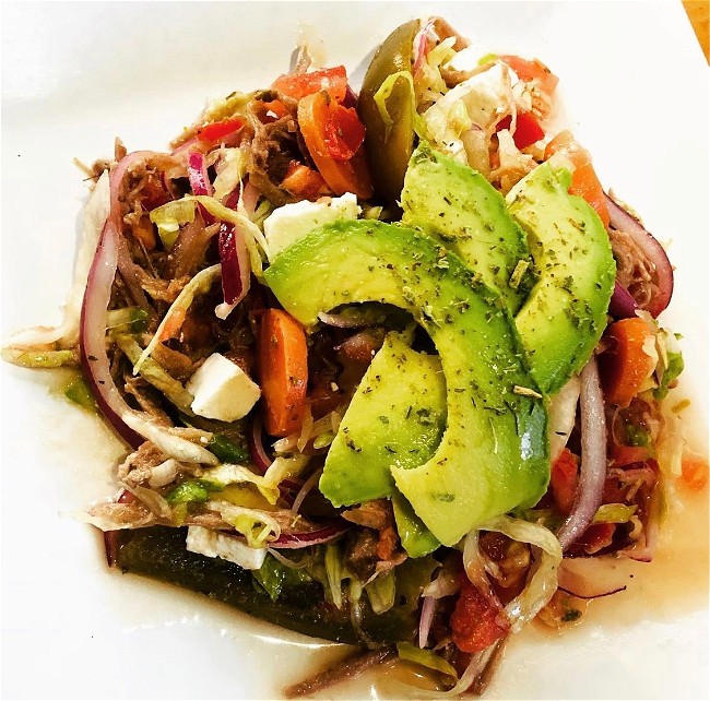 Image of Salpicón (shredded beef salad with onion, tomato, and avocado)