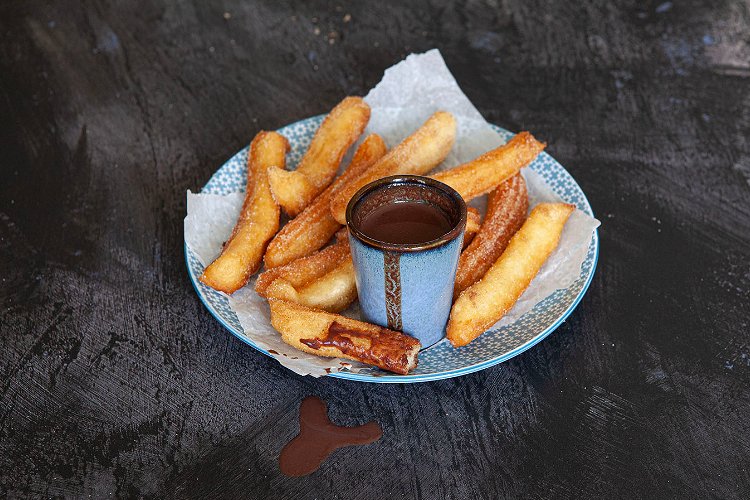 Image of Serve the warm churros dipped in the gorgeous dipping sauce.