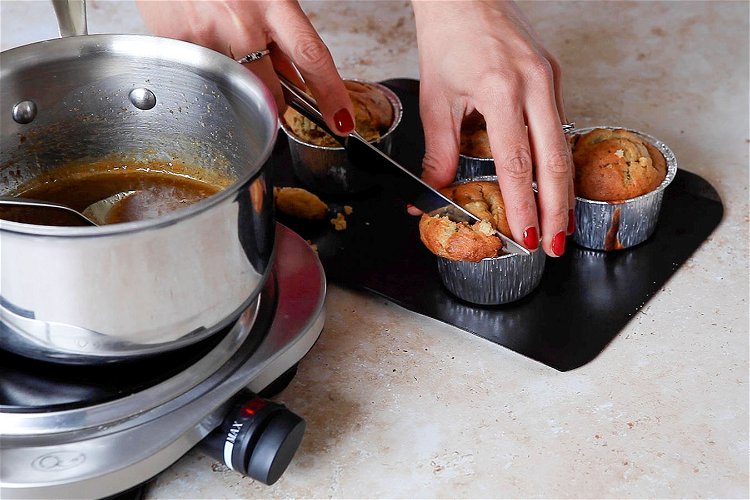 Image of Take the puddings out of the oven. Insert a fork...