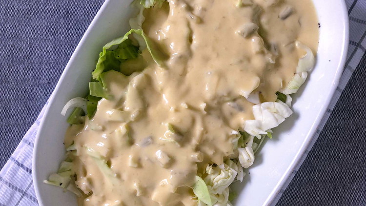 Image of Spread the condensed soup and mayonnaise mixture over the cabbage and onions. Cover the casserole pan with tin foil and bake at 350 for 30 minutes.
