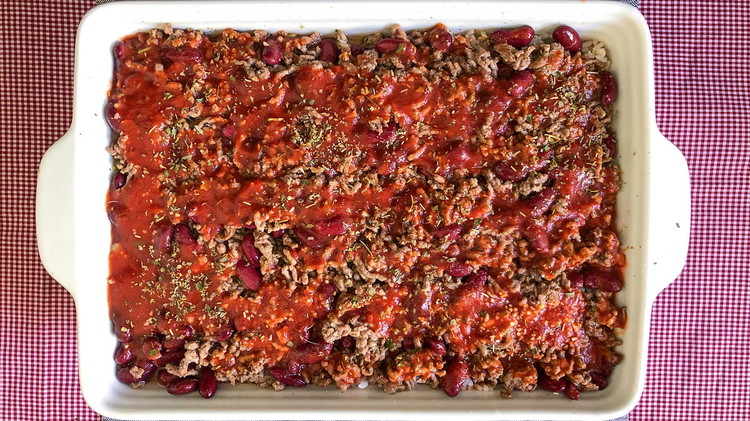 Image of Pour the beef and bean mixture over the rice and add the rest of the tomato mixture.