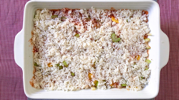 Image of Spread an even layer of rice. Season again with salt and pepper. Add one cup of water.