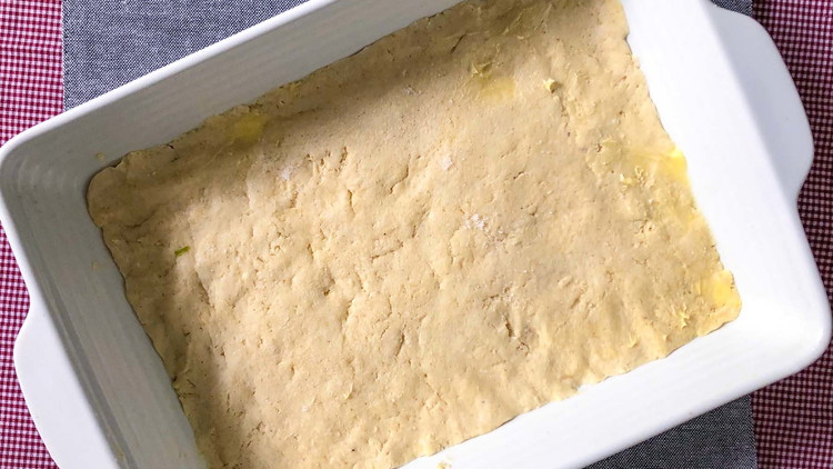 Image of Roll out an even layer of dough on greased 9x13 casserole pan.