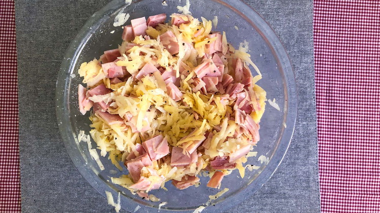 Image of Mix grated potatoes and ham. Combine half of the sauce mixture.