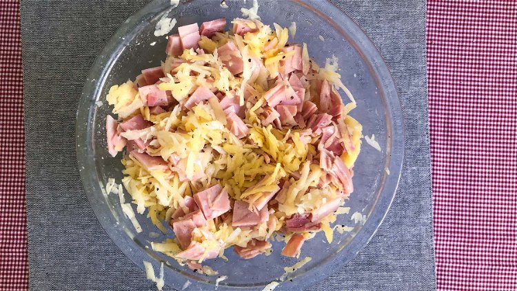 Image of Mix grated potatoes and ham. Combine half of the sauce...