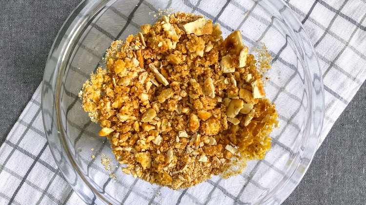 Image of Preheat oven to 425°. Combine cracker crumbles with melted butter. Set aside.