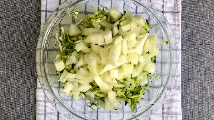 Image of Combine chopped onions with grated zucchini. Mix well.