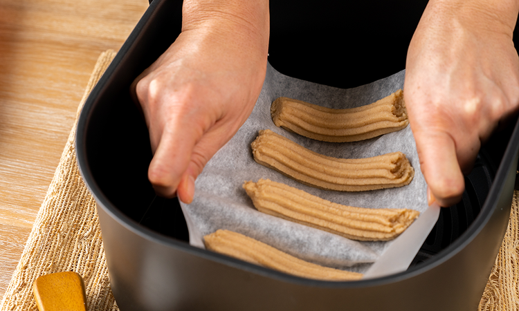 Image of Pipe 3-inch long pieces in a single layer in the air fryer basket. 