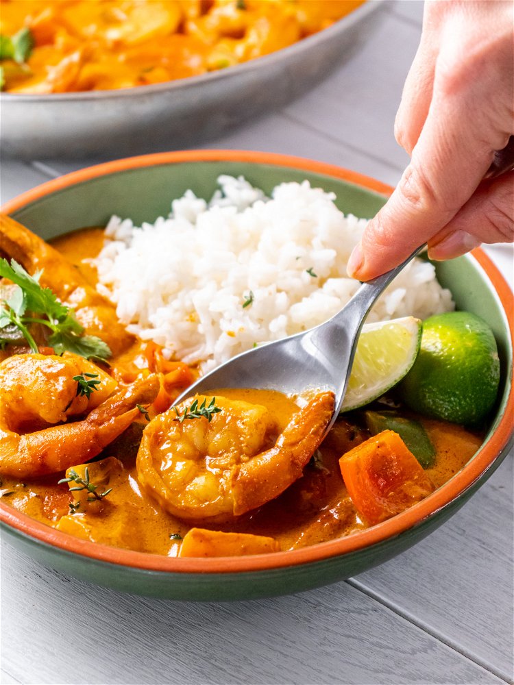 Image of Serve curry hot with rice, cilantro and lime wedges and...