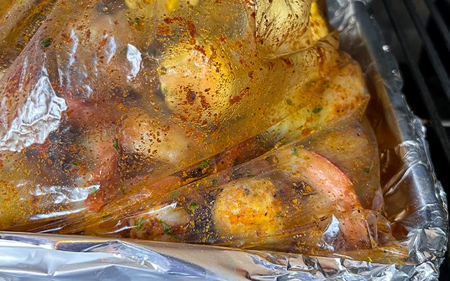Image of Fill an oven safe roasting bag with half the potatoes,...