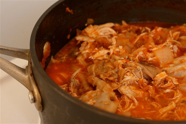 Image of Tinga de pollo (shredded chicken in tomato and chipotle sauce)