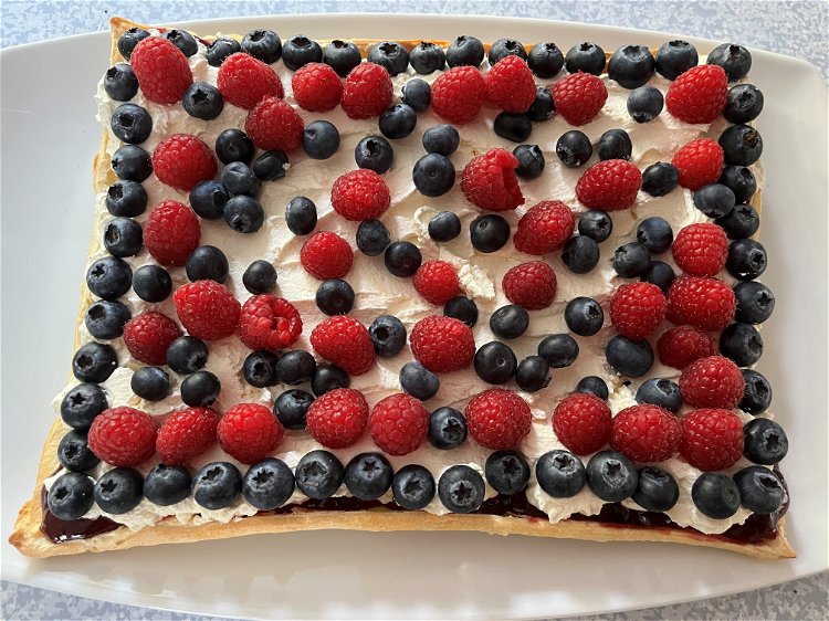 Image of Top with half the blueberries and some raspberries.