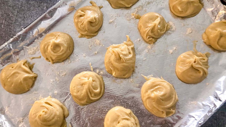 Image of On a greased and floured baking sheet, drop a rounded teaspoon of dough. Flatten with a floured spoon for crispier thinner cookies.