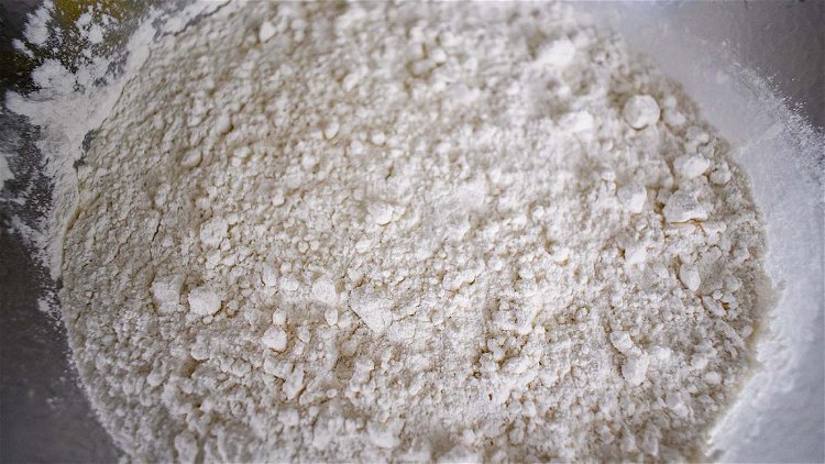 Image of Sift flour and salt together and add in shortening.