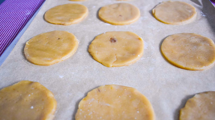 Image of Using half the cookie dough, roll out the dough to about 1/8 -¼ inch thick. Use a round 2 ¼ cookie cutter to cut circles out of dough.
