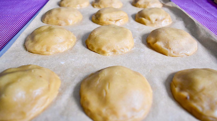 Image of Roll out the remaining cookie dough, and cut out circles the same size. Place the top circle over the raisin filling, and seal the edges together. With a knife, slice a small 1/2-inch line in the center of the cookie.
